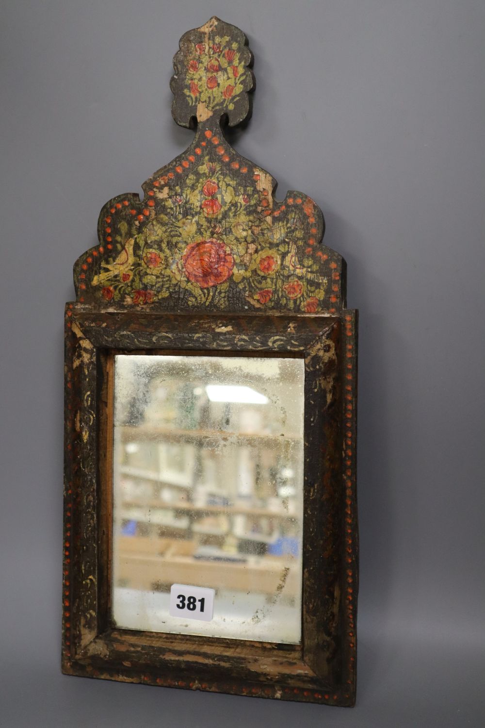 An Indian painted wall mirror, height 46cm